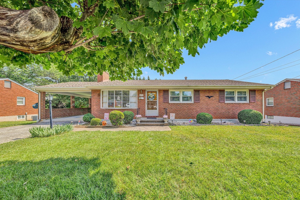 4711 Florist Rd NW, Roanoke, VA 24012 - single story home with concrete driveway, a chimney, brick siding, and a front yard