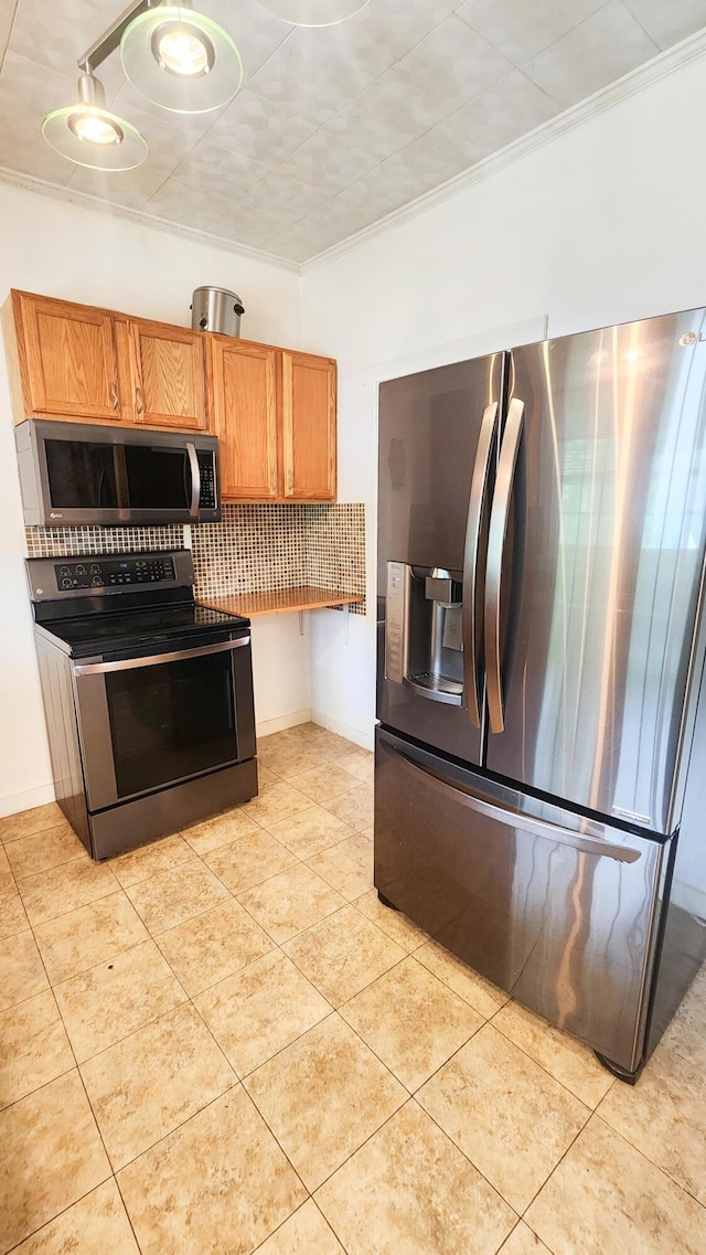 611 Alleghany St, Clifton Forge, VA 24422 - kitchen featuring appliances with stainless steel finishes, backsplash, brown cabinetry, light tile patterned flooring, and baseboards