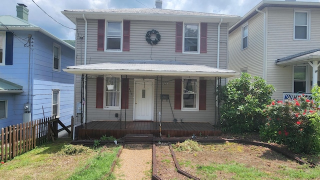 611 Alleghany St, Clifton Forge, VA 24422 - view of front facade featuring covered porch, a vegetable garden, and a chimney