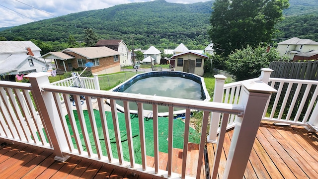 611 Alleghany St, Clifton Forge, VA 24422 - wooden deck featuring an outdoor structure and a forest view