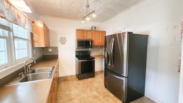 611 Alleghany St, Clifton Forge, VA 24422 - kitchen featuring stainless steel appliances, a sink, backsplash, crown molding, and brown cabinetry