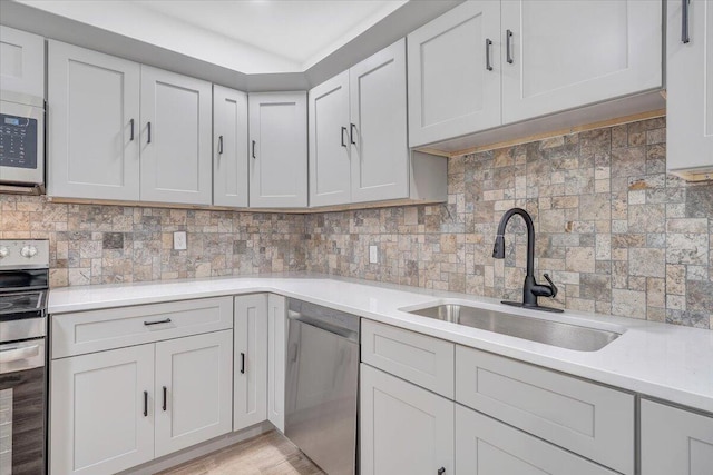 496 Boyd St, Buchanan, VA 24066 - kitchen with appliances with stainless steel finishes, light countertops, backsplash, and light wood-style flooring