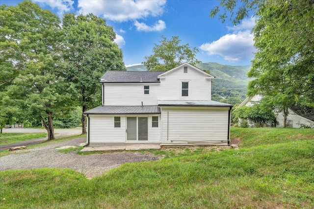 496 Boyd St, Buchanan, VA 24066 - back of house featuring a metal roof, a patio area, a lawn, and a mountain view