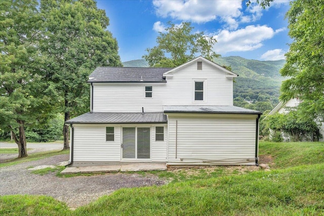 496 Boyd St, Buchanan, VA 24066 - rear view of house with a patio area, a metal roof, a mountain view, and a yard