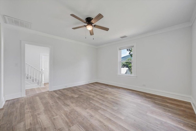 496 Boyd St, Buchanan, VA 24066 - spare room featuring light wood-style floors, ornamental molding, a ceiling fan, and stairway