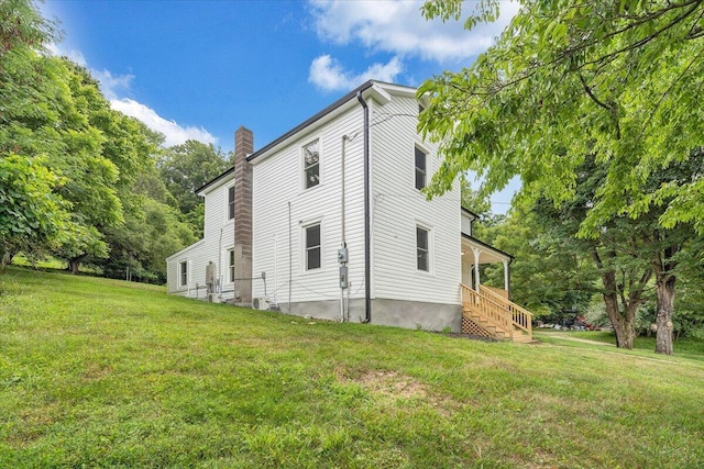 496 Boyd St, Buchanan, VA 24066 - view of side of property featuring a yard, a chimney, and stairs