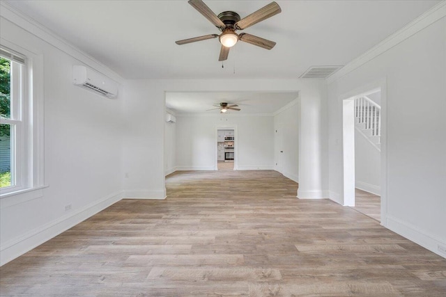 496 Boyd St, Buchanan, VA 24066 - spare room with an AC wall unit, ceiling fan, light wood finished floors, and crown molding
