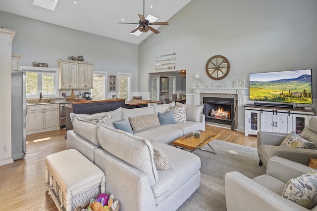 800 Long Island Dr, Moneta, VA 24121 - living room with high vaulted ceiling, light wood finished floors, ceiling fan, and a lit fireplace