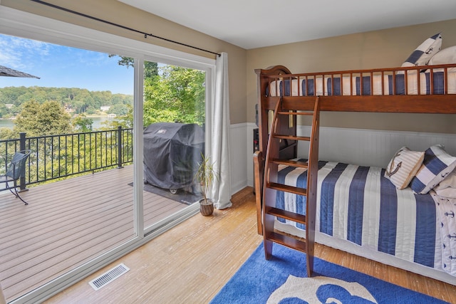 800 Long Island Dr, Moneta, VA 24121 - bedroom featuring access to outside, a wainscoted wall, and wood finished floors