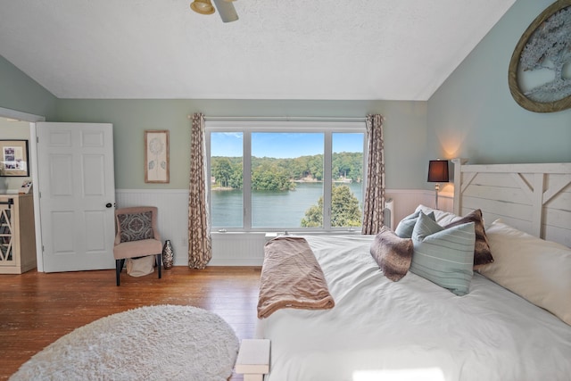 800 Long Island Dr, Moneta, VA 24121 - bedroom featuring vaulted ceiling, wood finished floors, a wainscoted wall, a ceiling fan, and a textured ceiling