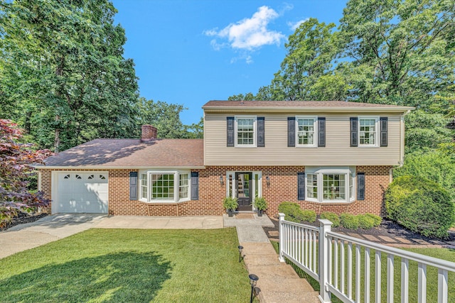 134 Sawyer Dr, Salem, VA 24153 - colonial home with a front yard, a garage, concrete driveway, and brick siding
