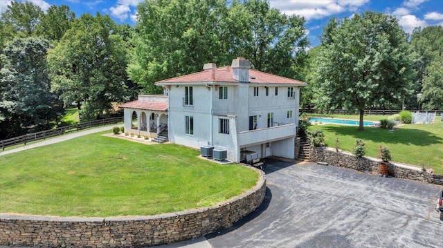 5880 Sugar Loaf Mountain Rd, Roanoke, VA 24018 - rear view of house featuring asphalt driveway, a garage, stairs, a chimney, and stucco siding