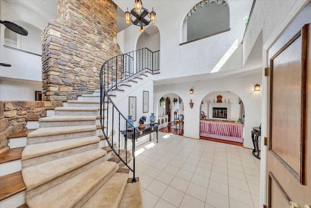 5880 Sugar Loaf Mountain Rd, Roanoke, VA 24018 - foyer entrance with arched walkways, light tile patterned floors, a high ceiling, and stairs