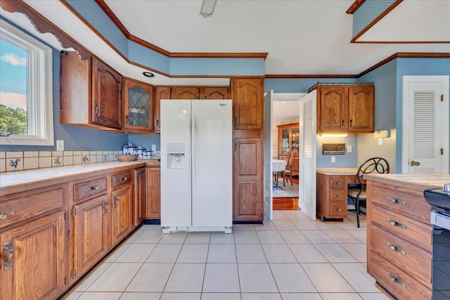 5880 Sugar Loaf Mountain Rd, Roanoke, VA 24018 - kitchen with white refrigerator with ice dispenser, crown molding, brown cabinets, tile countertops, and glass insert cabinets
