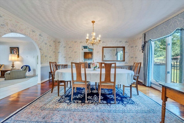 5880 Sugar Loaf Mountain Rd, Roanoke, VA 24018 - dining room featuring wallpapered walls, ornamental molding, wood finished floors, arched walkways, and a chandelier