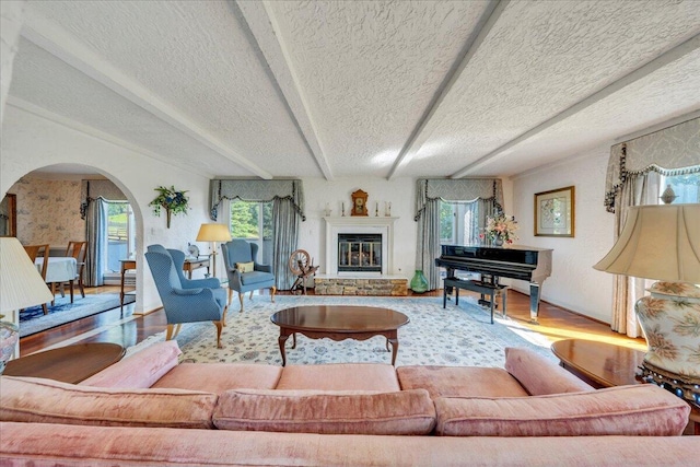 5880 Sugar Loaf Mountain Rd, Roanoke, VA 24018 - living area with arched walkways, wood finished floors, a textured ceiling, and a glass covered fireplace