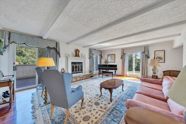 5880 Sugar Loaf Mountain Rd, Roanoke, VA 24018 - living room featuring wood finished floors, a textured ceiling, a glass covered fireplace, and beamed ceiling