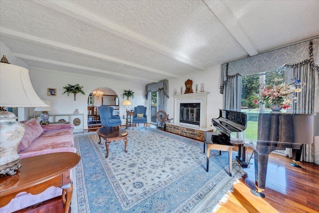 5880 Sugar Loaf Mountain Rd, Roanoke, VA 24018 - living room featuring wood finished floors, healthy amount of natural light, arched walkways, a textured ceiling, and a glass covered fireplace