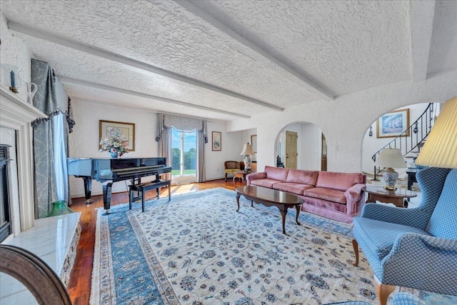 5880 Sugar Loaf Mountain Rd, Roanoke, VA 24018 - living area featuring stairs, wood finished floors, a textured ceiling, a textured wall, and beam ceiling