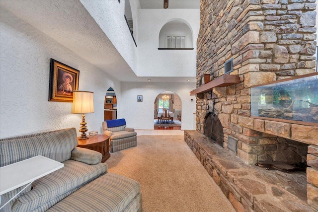 5880 Sugar Loaf Mountain Rd, Roanoke, VA 24018 - living area featuring arched walkways, carpet, a fireplace, and a high ceiling