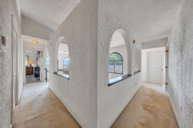 5880 Sugar Loaf Mountain Rd, Roanoke, VA 24018 - hallway featuring a textured ceiling, light colored carpet, arched walkways, and a textured wall