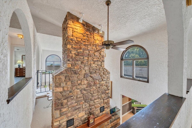 5880 Sugar Loaf Mountain Rd, Roanoke, VA 24018 - detailed view of a textured wall, a textured ceiling, arched walkways, and a ceiling fan