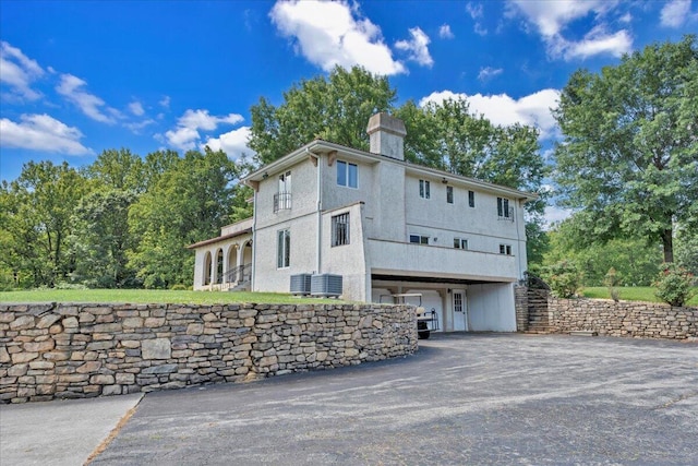 5880 Sugar Loaf Mountain Rd, Roanoke, VA 24018 - view of side of property with a chimney, driveway, and stucco siding
