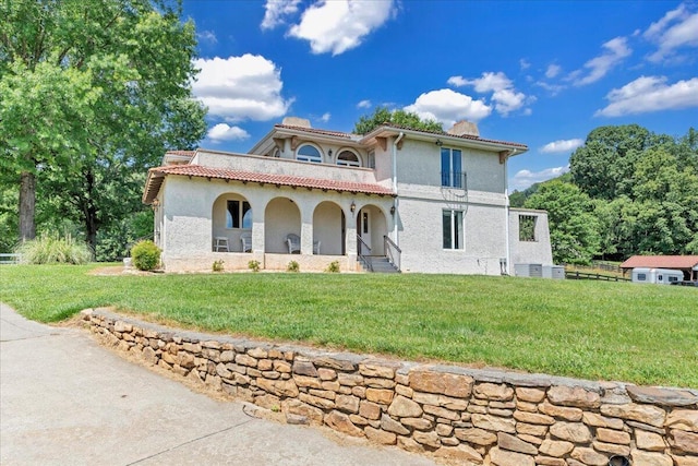5880 Sugar Loaf Mountain Rd, Roanoke, VA 24018 - mediterranean / spanish-style home featuring covered porch, a chimney, stucco siding, and a front lawn