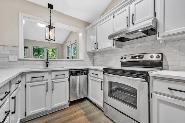 8757 Bent Mountain Rd, Roanoke, VA 24018 - kitchen featuring stainless steel appliances, under cabinet range hood, lofted ceiling, white cabinets, and backsplash