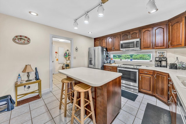 30 Island Green Cir Unit 22, Penhook, VA 24137 - kitchen featuring stainless steel appliances, light tile patterned floors, a kitchen island, a breakfast bar, and light countertops