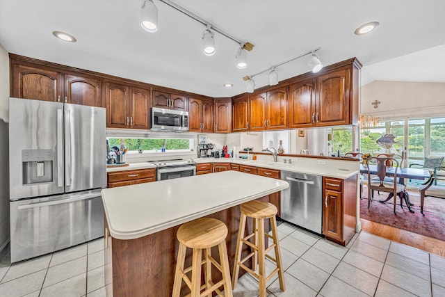30 Island Green Cir Unit 22, Penhook, VA 24137 - kitchen featuring stainless steel appliances, light tile patterned floors, a peninsula, light countertops, and lofted ceiling