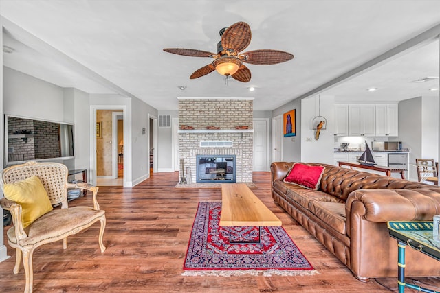 30 Island Green Cir Unit 22, Penhook, VA 24137 - living room with a ceiling fan, light wood-style flooring, a brick fireplace, and recessed lighting