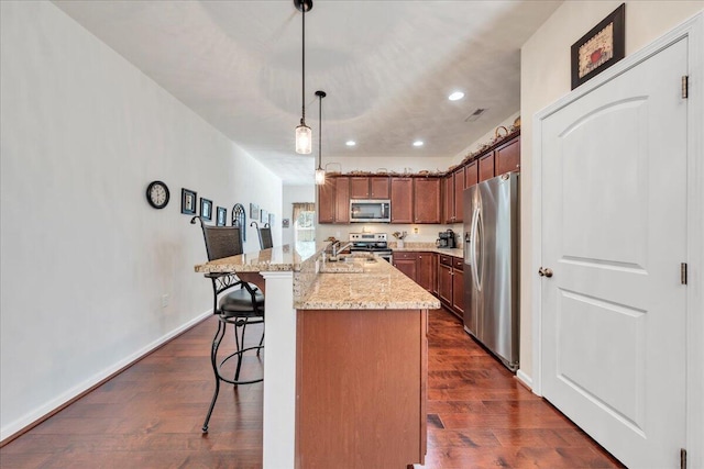 8355 Leighburn Dr, Roanoke, VA 24019 - kitchen featuring appliances with stainless steel finishes, recessed lighting, a breakfast bar area, light stone counters, and dark wood-style floors
