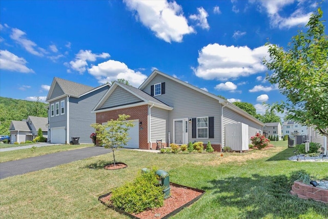 8355 Leighburn Dr, Roanoke, VA 24019 - traditional-style house featuring brick siding, a front yard, driveway, and a garage