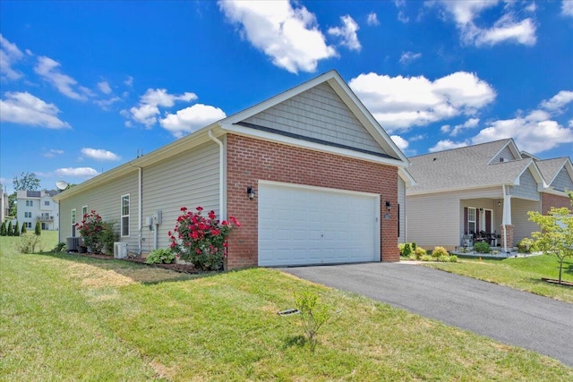 8355 Leighburn Dr, Roanoke, VA 24019 - view of side of home with brick siding, driveway, a yard, and an attached garage
