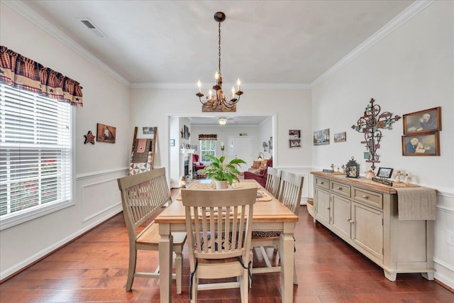 8355 Leighburn Dr, Roanoke, VA 24019 - dining room with healthy amount of natural light, a chandelier, ornamental molding, dark wood finished floors, and a wainscoted wall