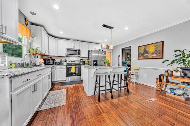 2343 Circle Dr SW, Roanoke, VA 24018 - kitchen featuring stainless steel appliances, tasteful backsplash, a breakfast bar, a kitchen island, and ornamental molding