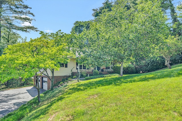2343 Circle Dr SW, Roanoke, VA 24018 - view of grassy yard featuring driveway and an attached garage