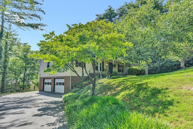 2343 Circle Dr SW, Roanoke, VA 24018 - view of front of home featuring driveway, an attached garage, brick siding, and a front lawn