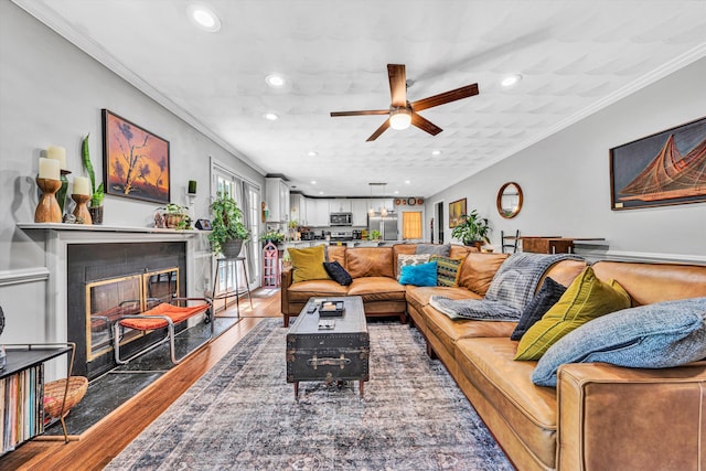 2343 Circle Dr SW, Roanoke, VA 24018 - living room featuring ceiling fan, wood finished floors, ornamental molding, recessed lighting, and a fireplace with flush hearth