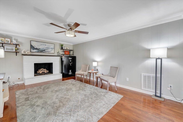 245 Queen Regent Ct, Blue Ridge, VA 24064 - living area with crown molding, a fireplace, wood finished floors, and a ceiling fan