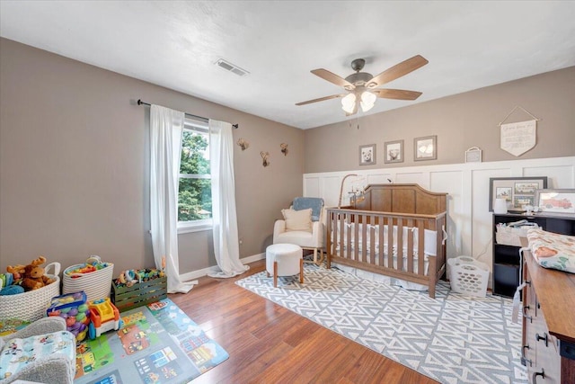 245 Queen Regent Ct, Blue Ridge, VA 24064 - bedroom with light wood finished floors, a nursery area, and a ceiling fan