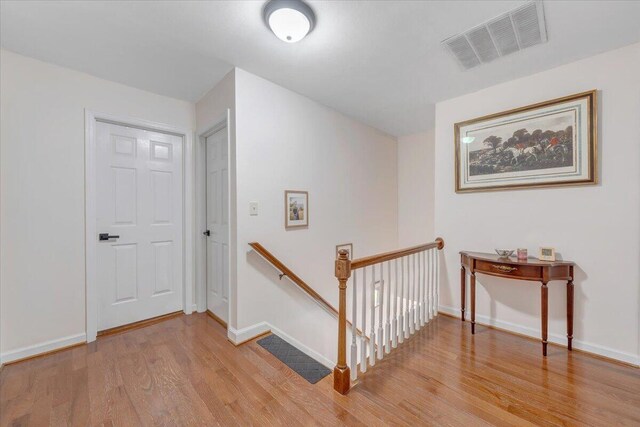245 Queen Regent Ct, Blue Ridge, VA 24064 - corridor with an upstairs landing and light wood-style flooring