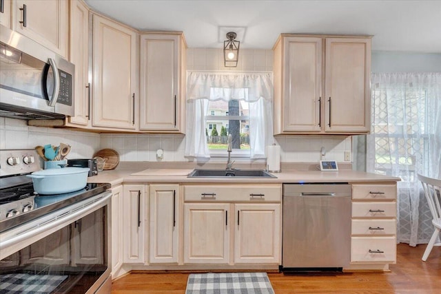 245 Queen Regent Ct, Blue Ridge, VA 24064 - kitchen featuring appliances with stainless steel finishes, light wood-style floors, light brown cabinets, and light countertops