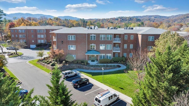 3040 Mcvitty Forest Dr Unit 211, Roanoke, VA 24018 - view of building exterior with uncovered parking and a mountain view