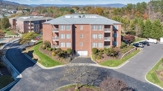 3040 Mcvitty Forest Dr Unit 211, Roanoke, VA 24018 - view of building exterior with a garage and asphalt driveway