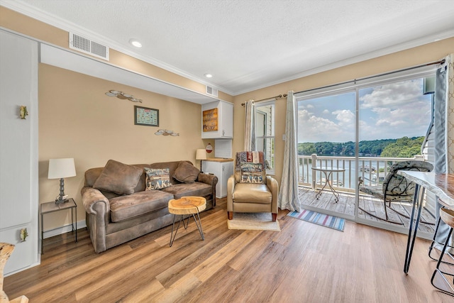 1085 Bluewater Dr Unit 220, Moneta, VA 24121 - living room with ornamental molding, light wood-style floors, healthy amount of natural light, recessed lighting, and a water view