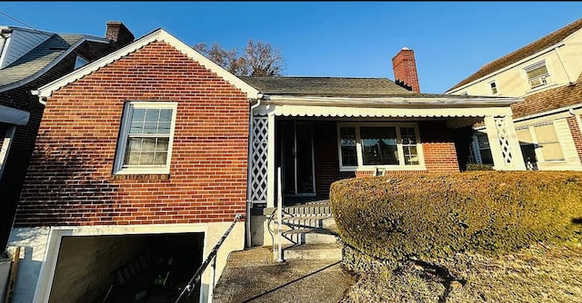214 E Madison St, Covington, VA 24426 - view of front of house featuring brick siding and a chimney