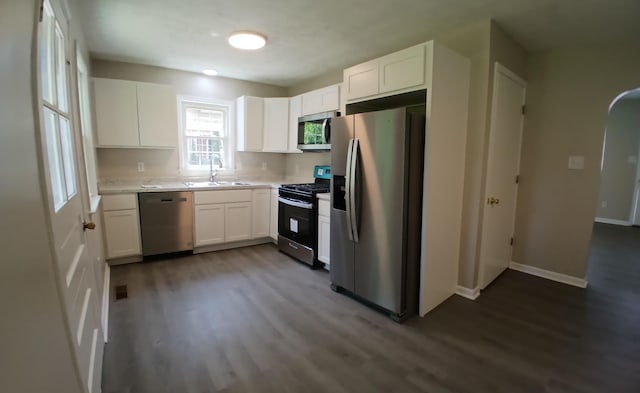 214 E Madison St, Covington, VA 24426 - kitchen featuring stainless steel appliances, dark wood-style floors, light countertops, and white cabinetry
