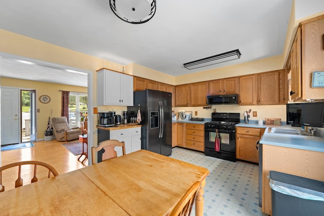 73 Bounty Ct, Roanoke, VA 24019 - kitchen with black appliances, light floors, and light countertops